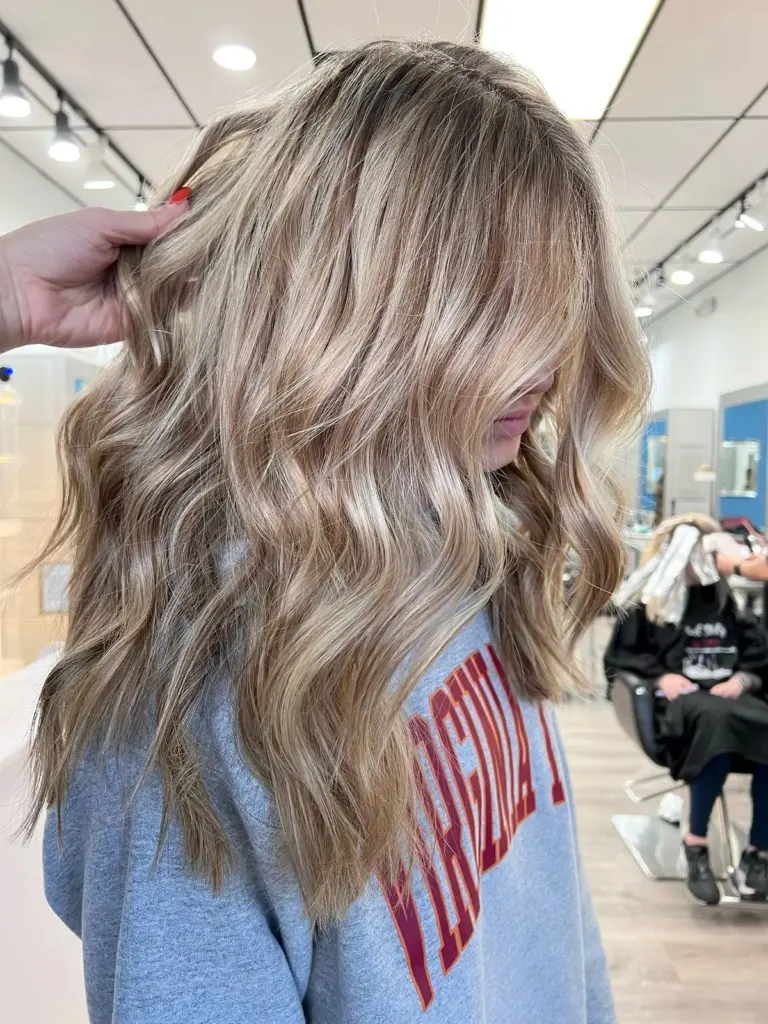 Cool ash blonde balayage in long, voluminous waves