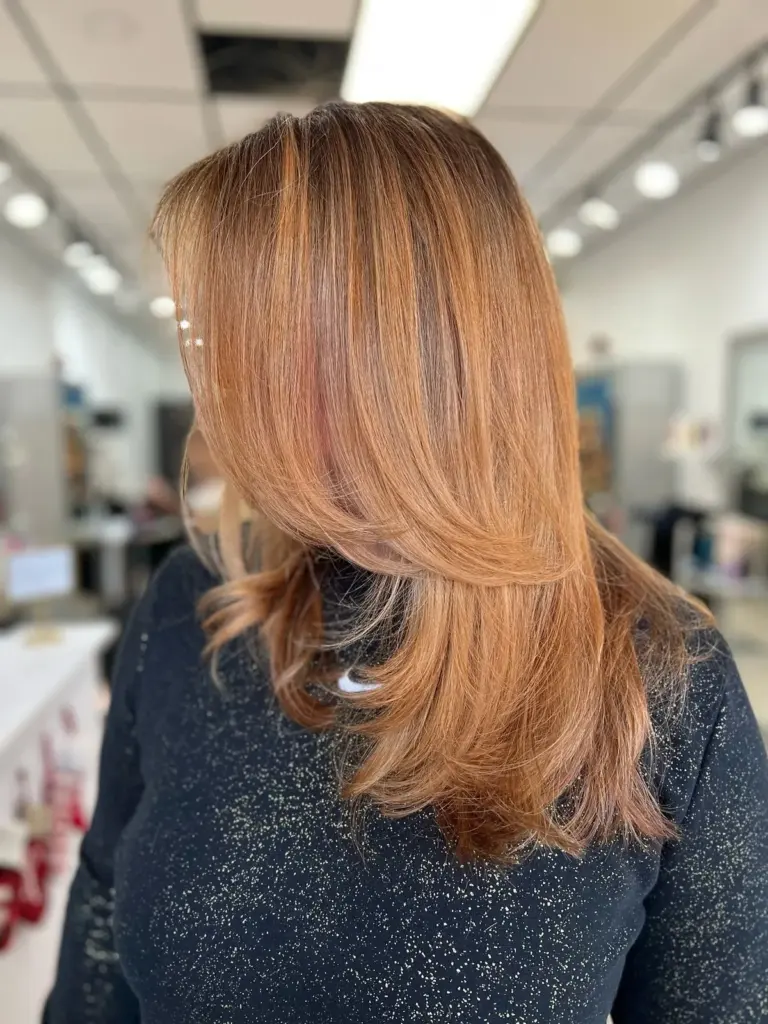 Long copper hair cut in soft, face-framing layers