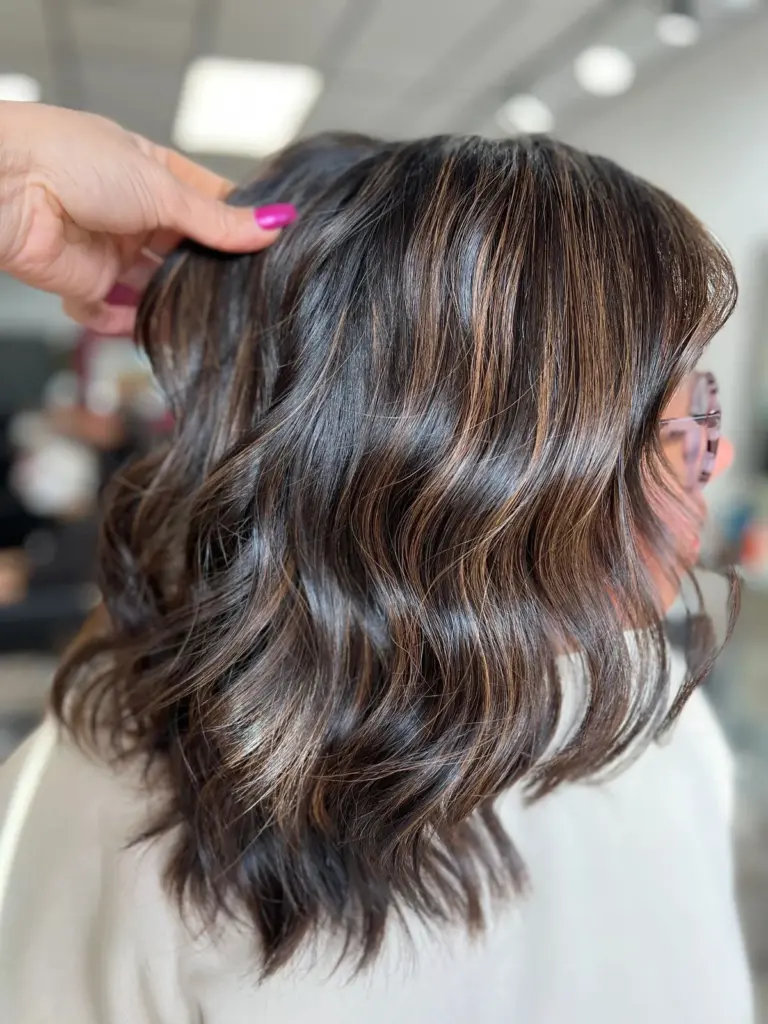 Dark brunette waves with subtle, low-contrast dimension