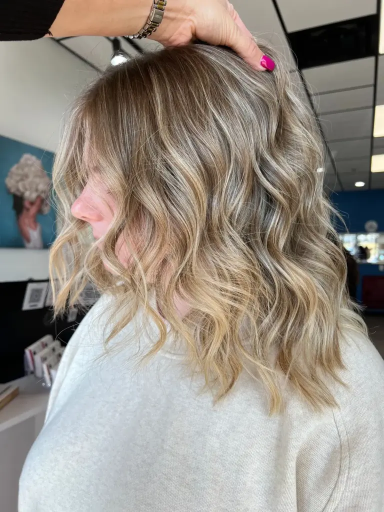 Side profile of soft blonde balayage waves
