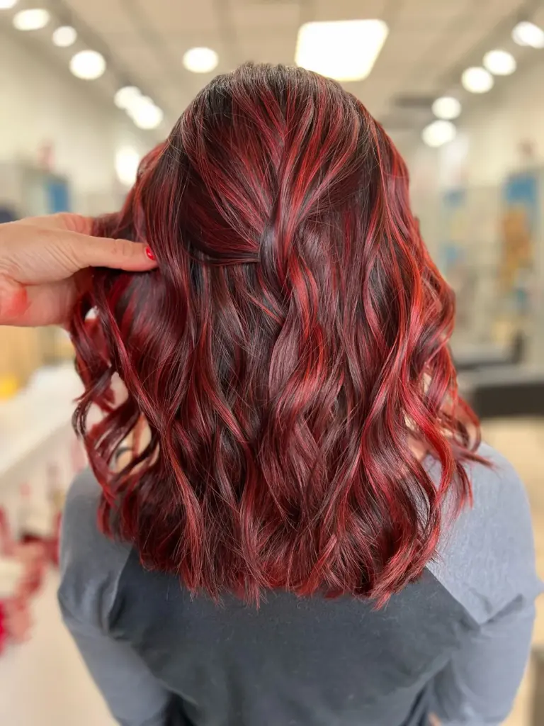 Vibrant red hair color styled in shoulder-length waves